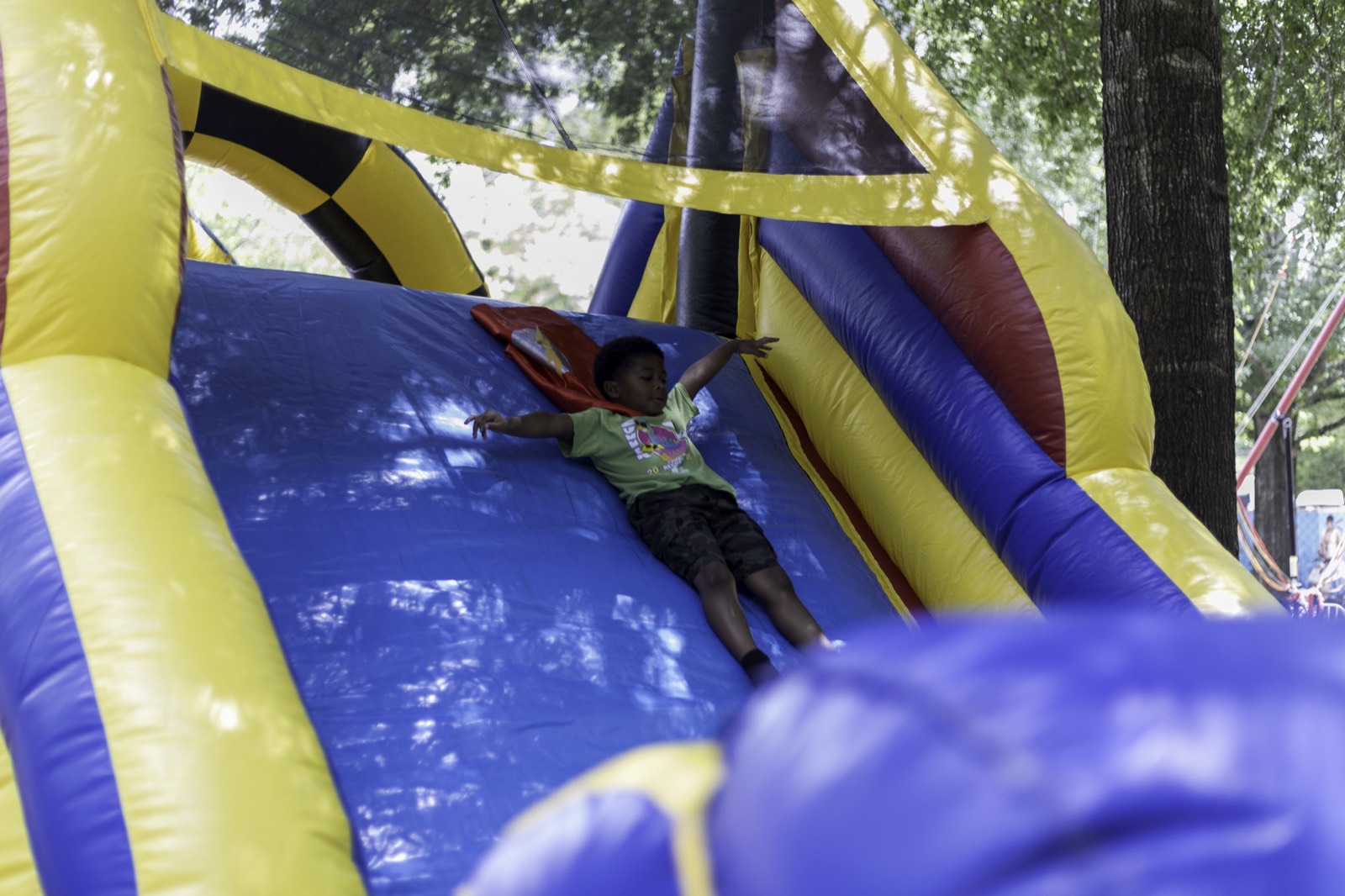 Kid sliding down the inflatable slide at Turbo Day 2025