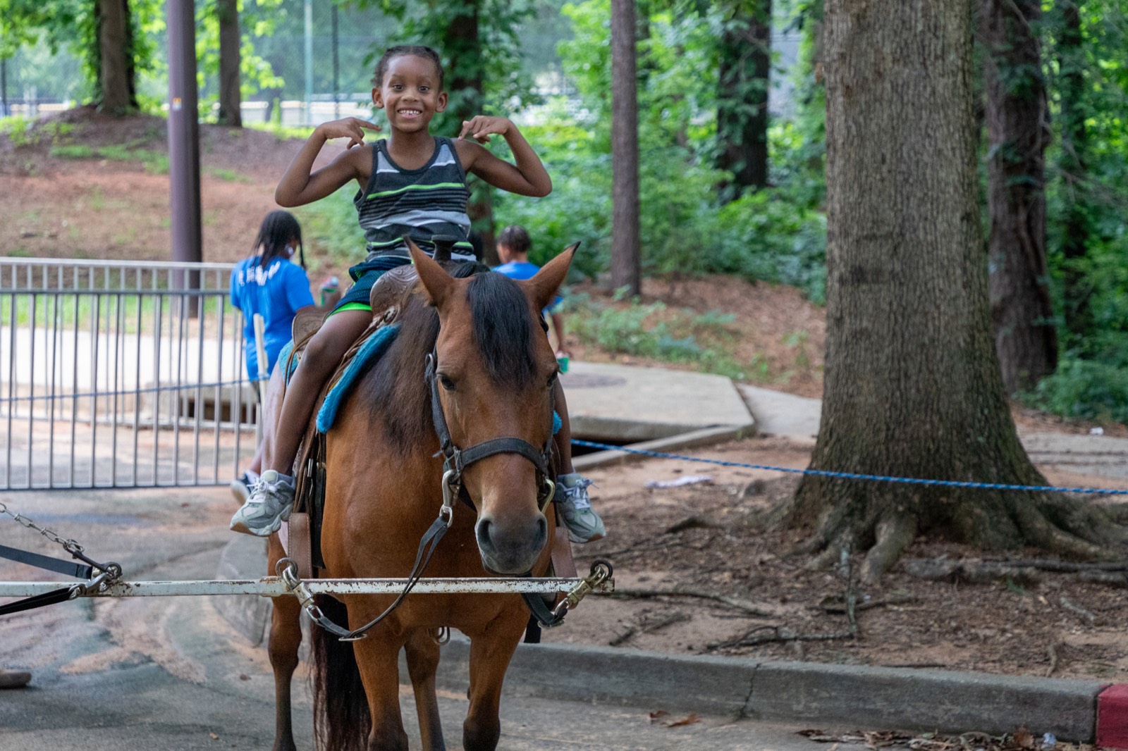 Kid flexing on a pony ride at Turbo Day