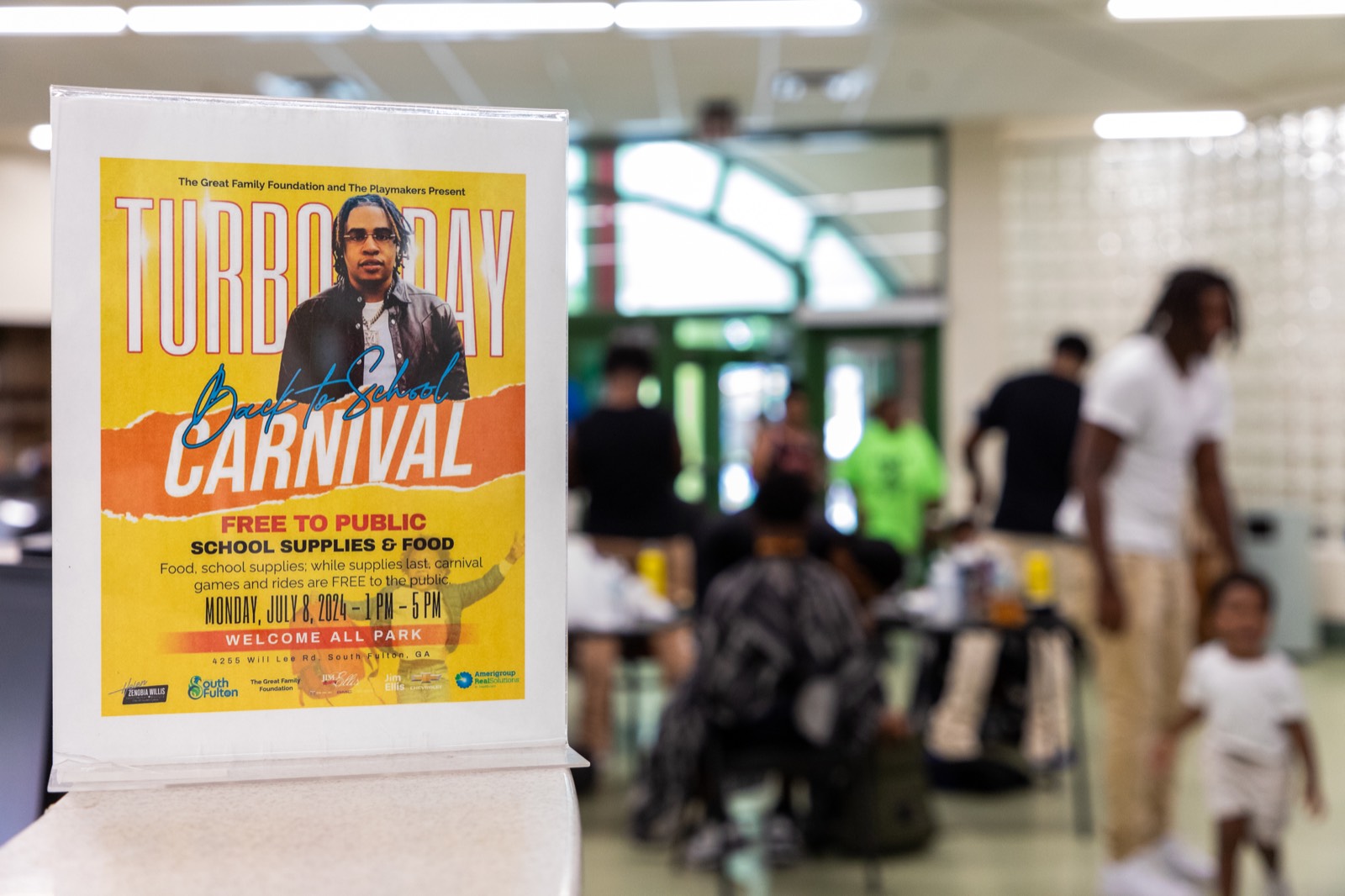 Turbo Day Back-to-School Carnival flyer with free haircuts in the background