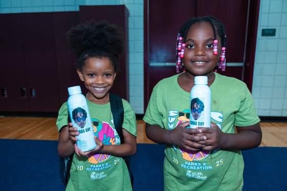 Young girls holding Turbo Day water bottles
