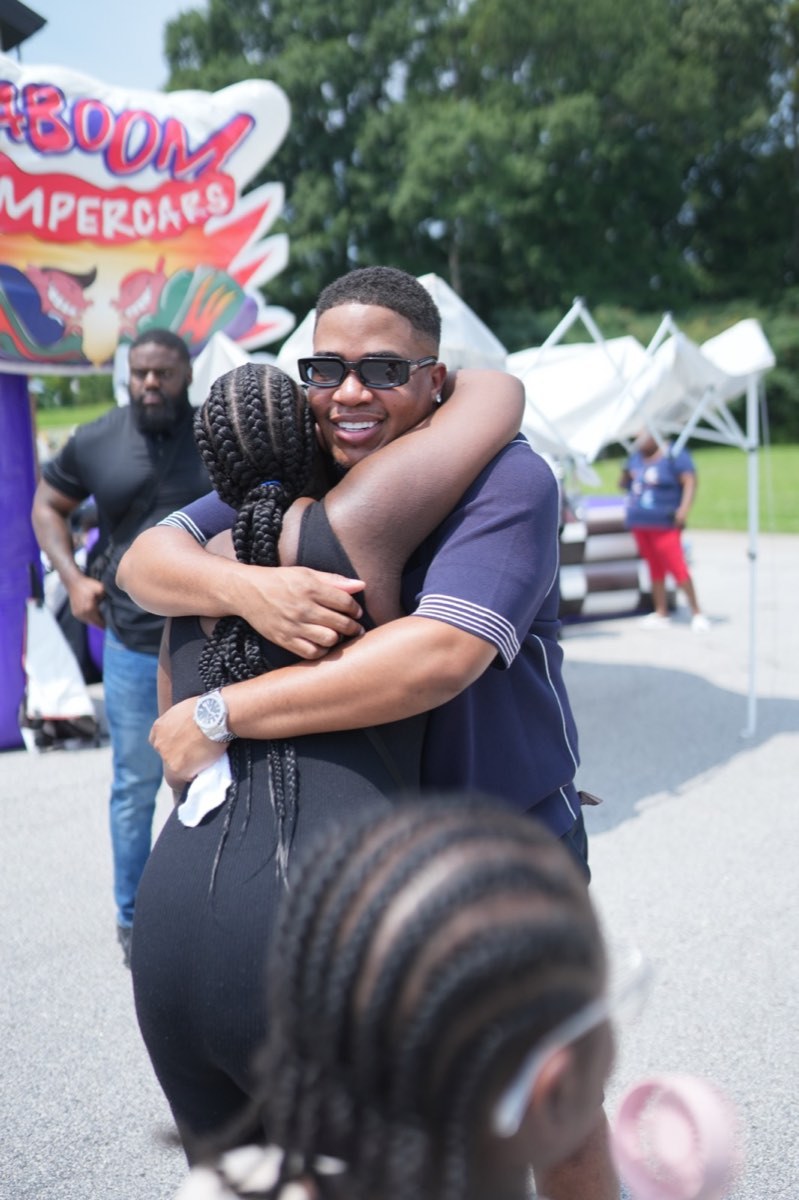 Turbo sharing a hug with a community member at Turbo Day 2026