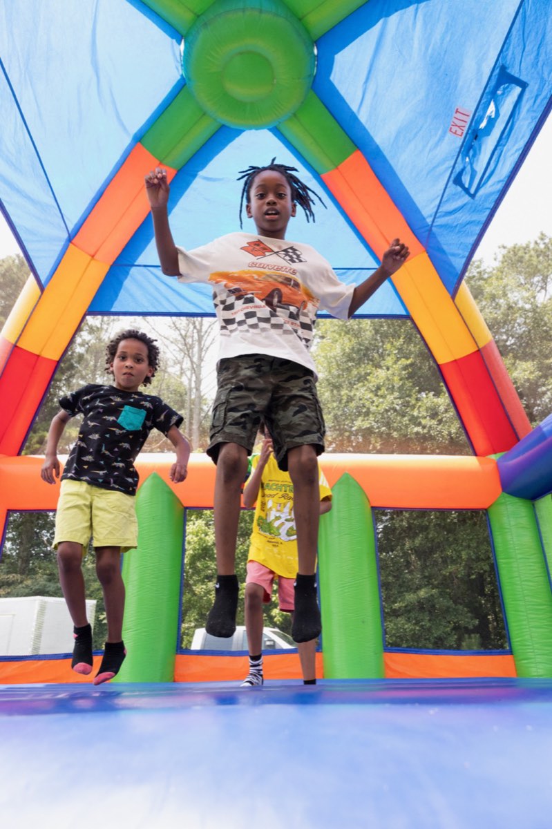 Kids jumping high inside the bounce house at Turbo Day 2026