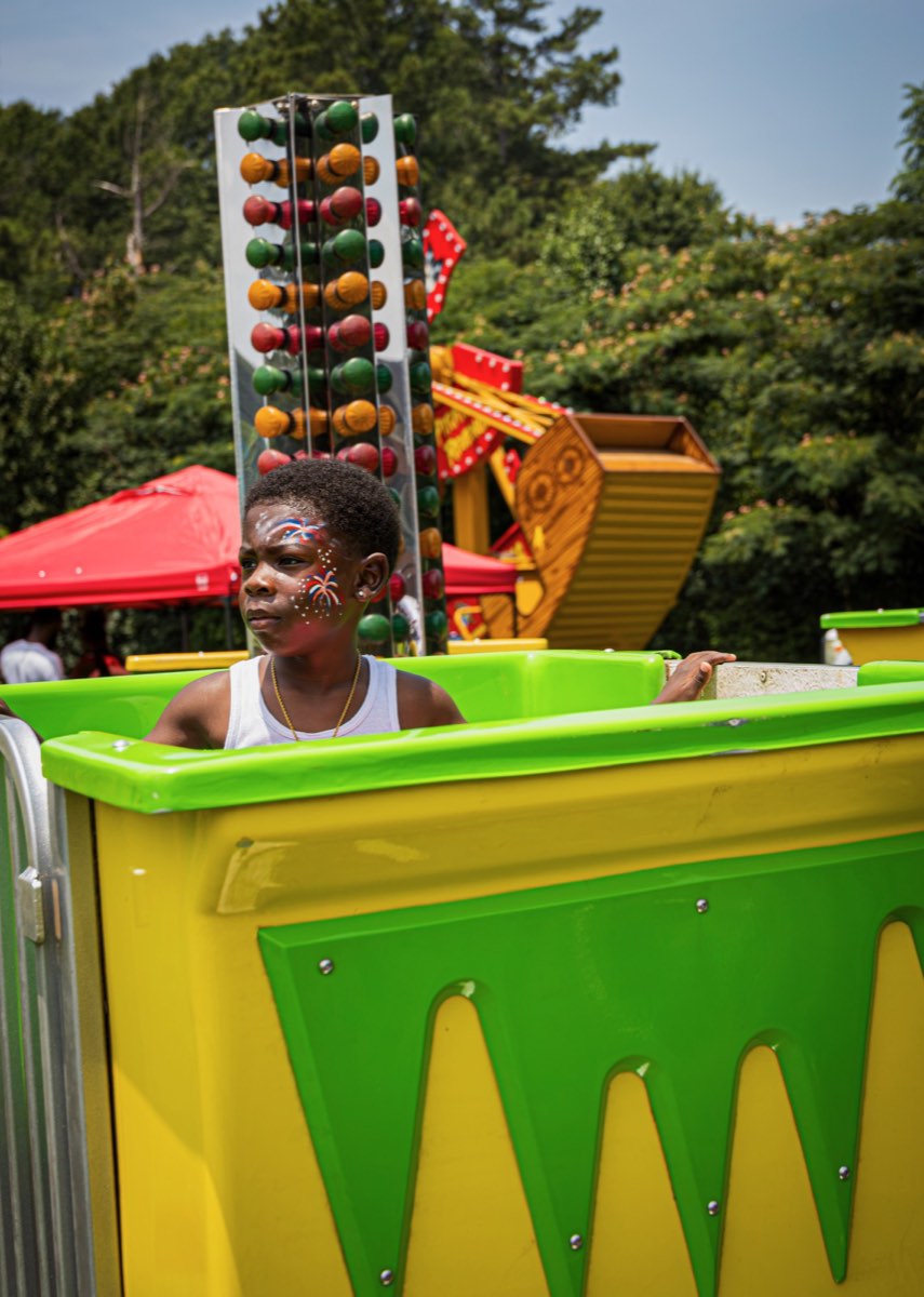 Boy with face paint riding a carnival ride at Turbo Day 2026