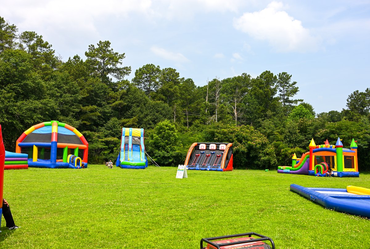 Rows of inflatable slides, bounce houses, and games across the field at Turbo Day 2026