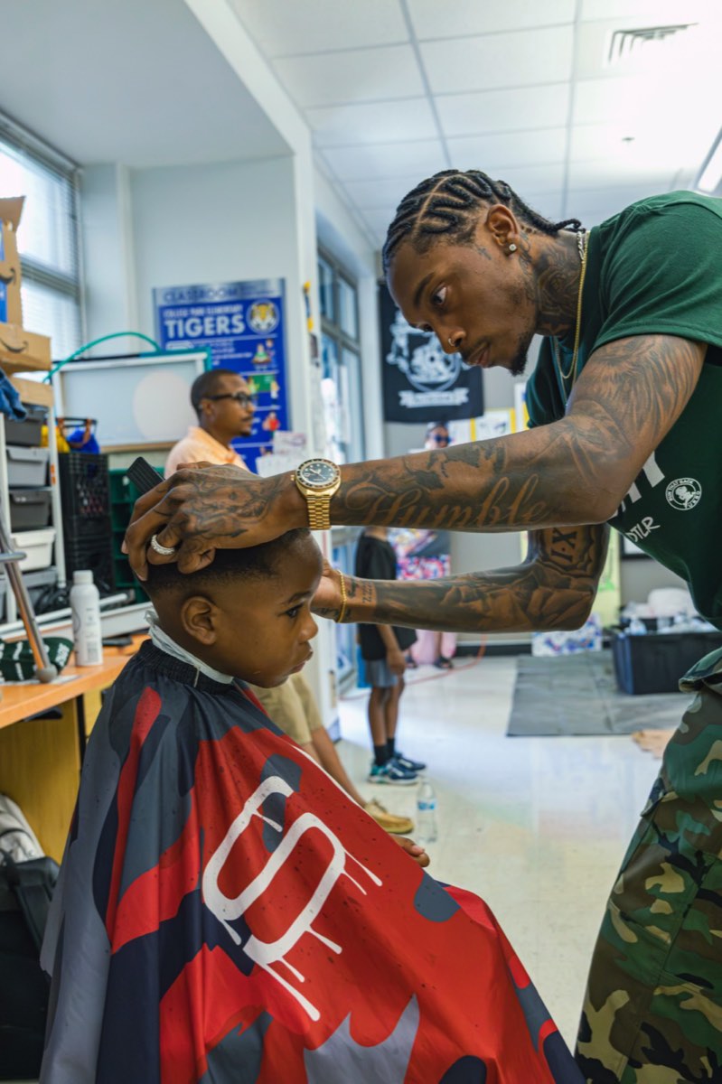 Barber giving a young boy a fresh haircut at Turbo Day 2026
