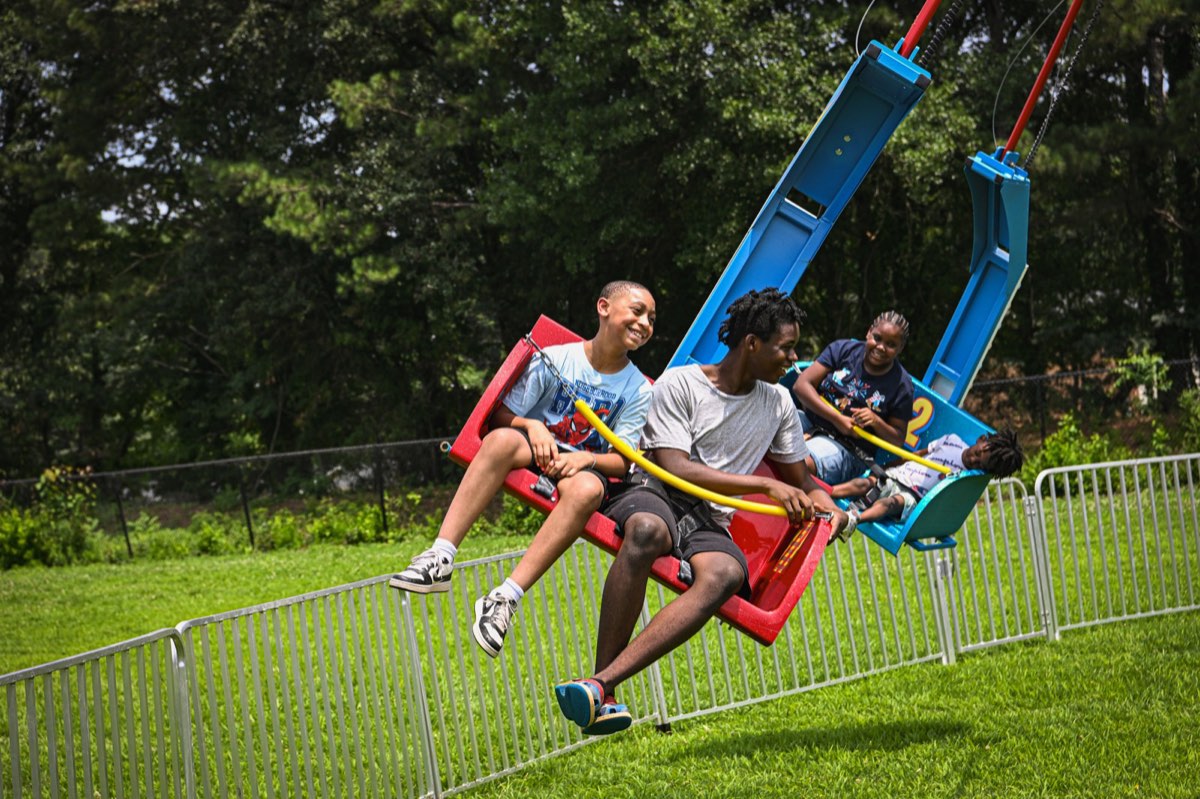 Teens laughing on the glider carnival ride at Turbo Day 2026