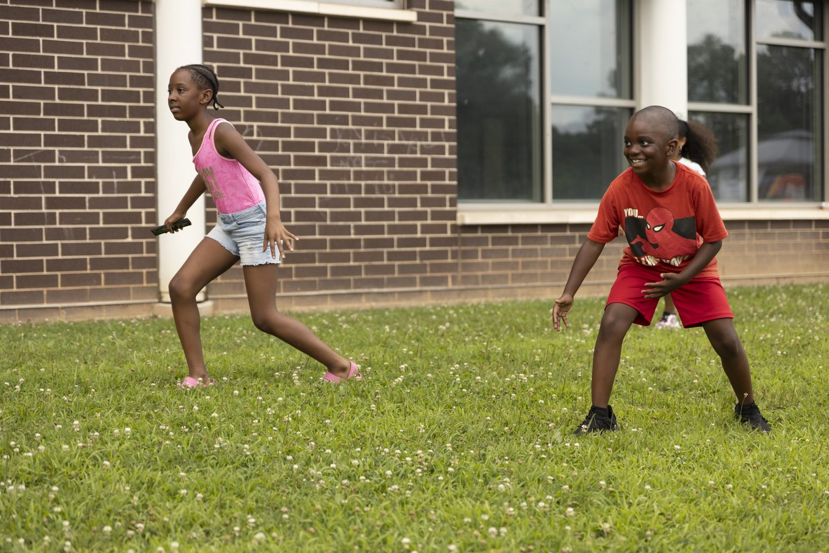 Two kids playing a game together on the grass at Turbo Day 2026