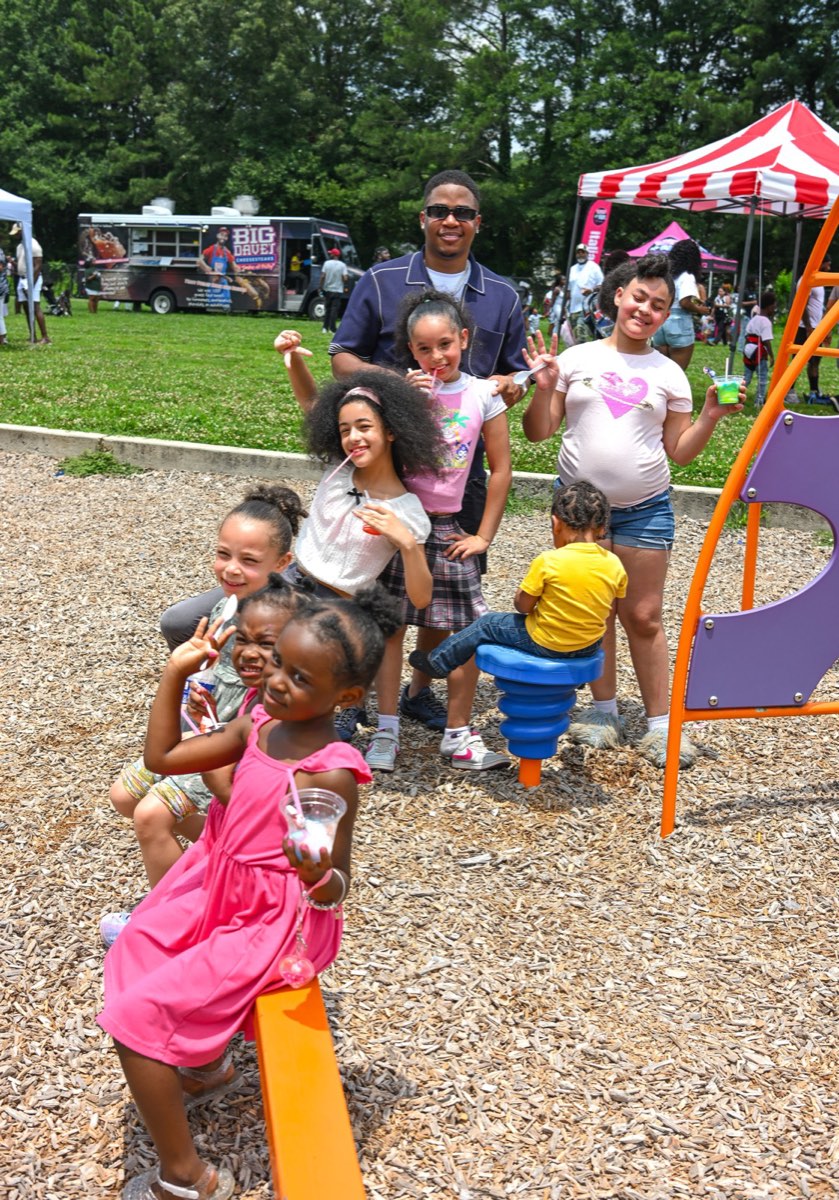 Turbo with a group of kids on the playground at Turbo Day 2026