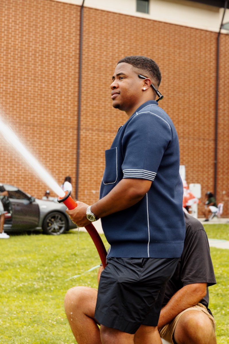 Turbo spraying a water hose to cool off the crowd at Turbo Day 2026